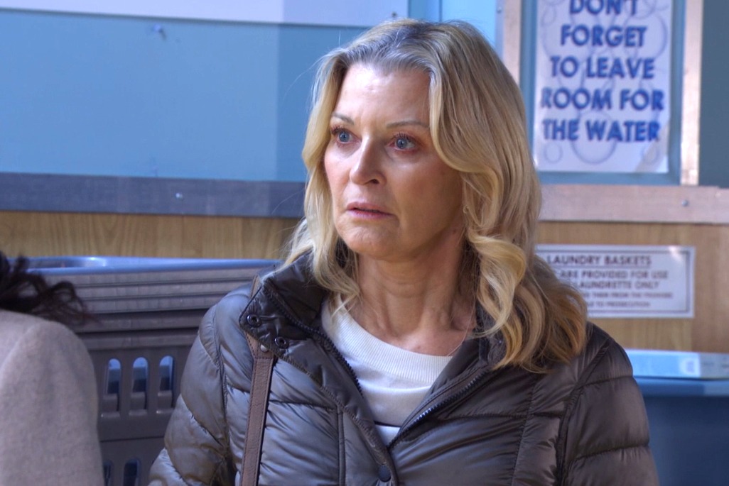 Kathy looking confused in the launderette in EastEnders